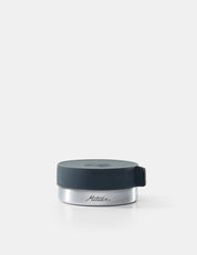 Silver container with a black lid on a white background