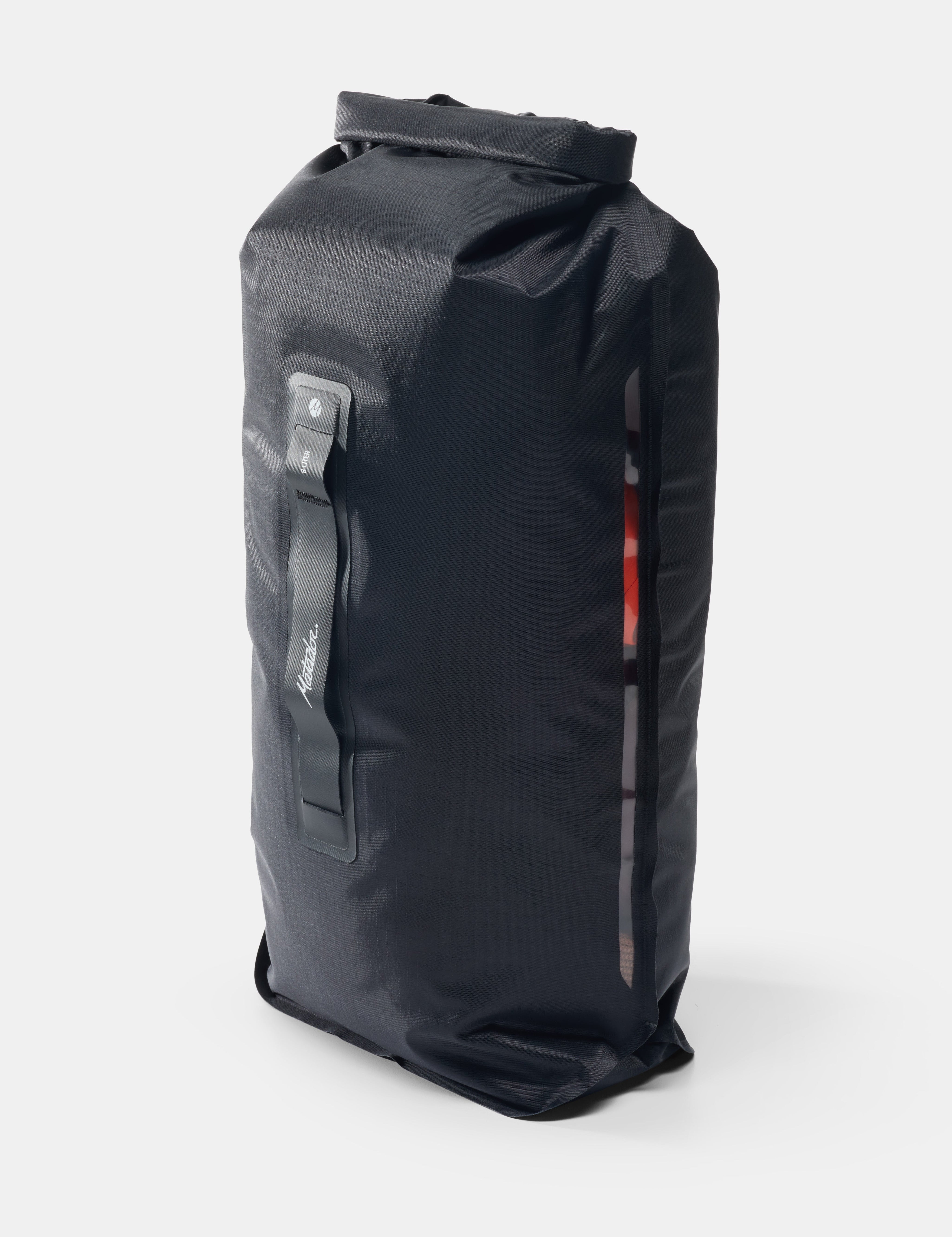 Black dry bag with a strap on a white background
