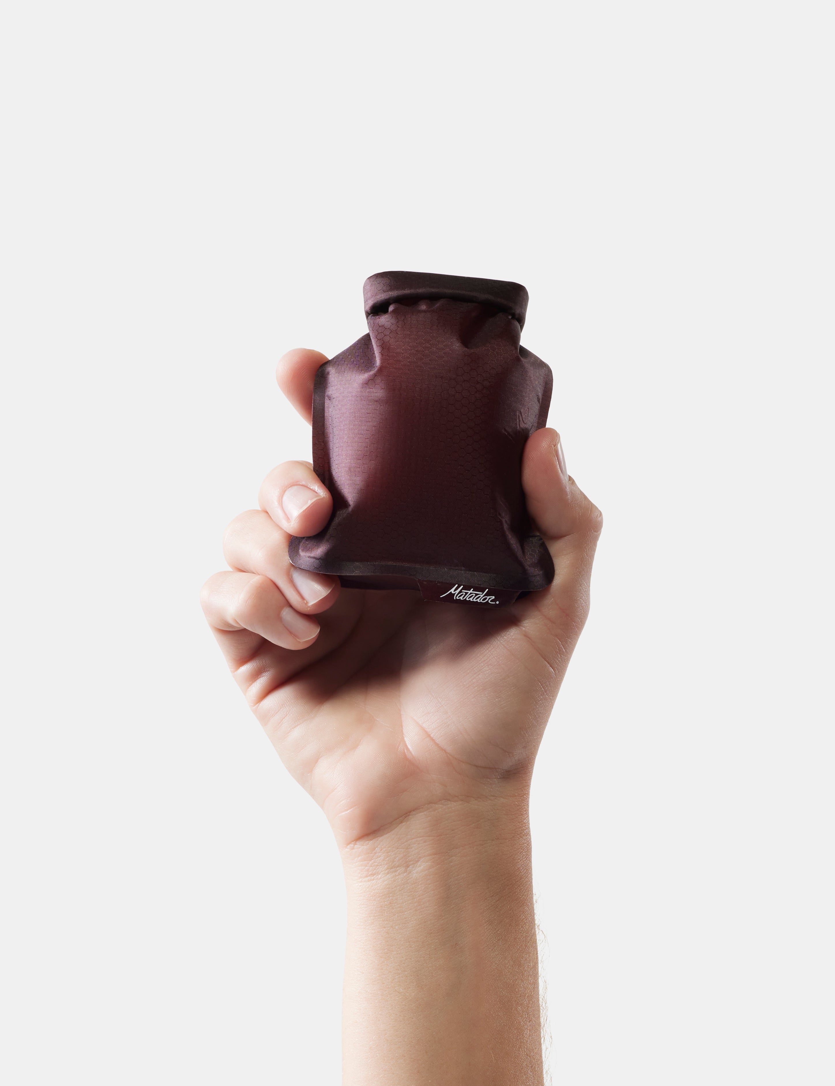 Hand holding garnet soap bar case on white background
