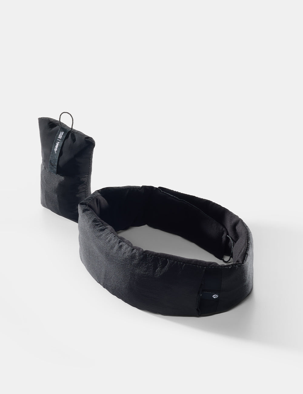 black sleep mask and pouch on white background