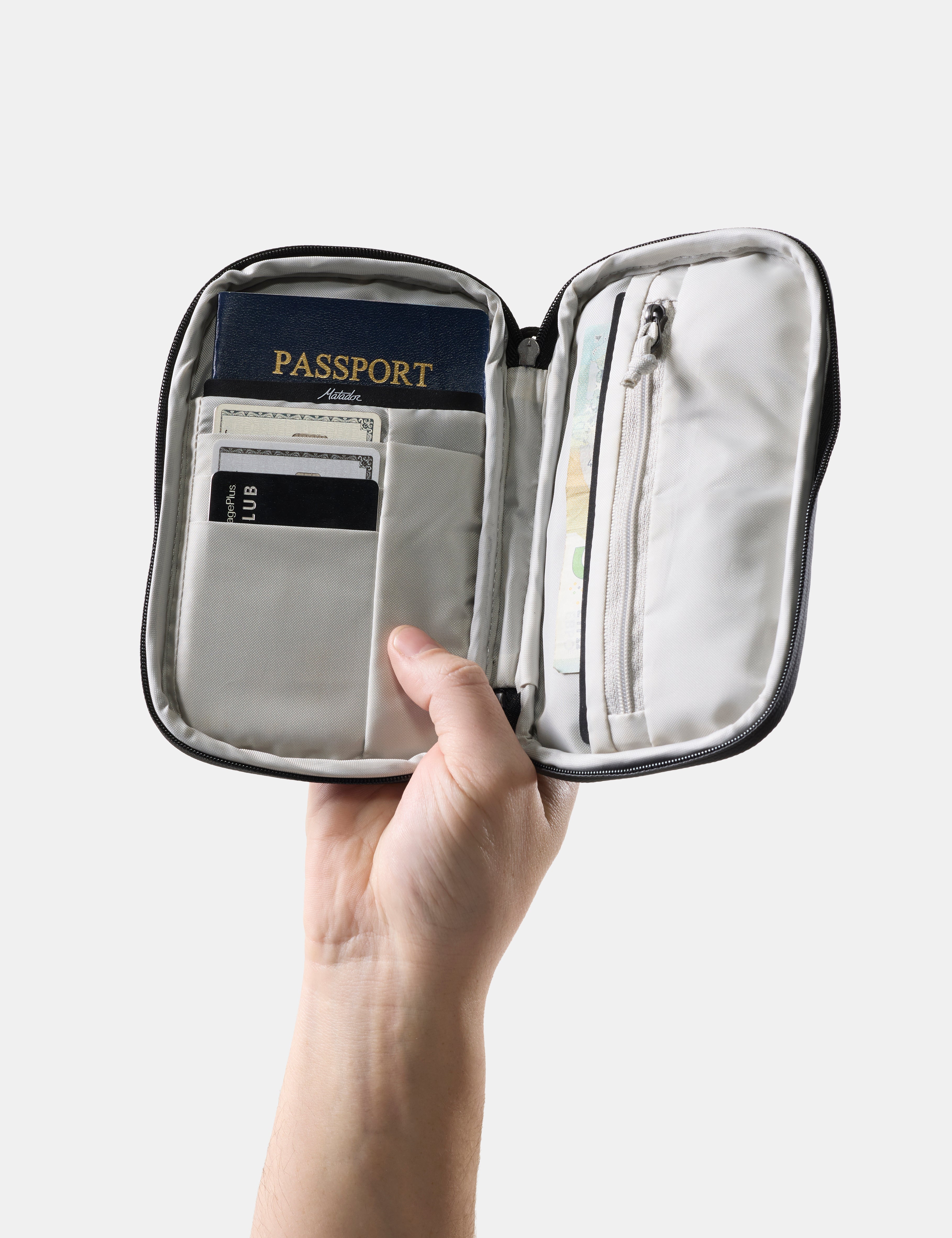 hand holding open travel wallet with passport and credit cards