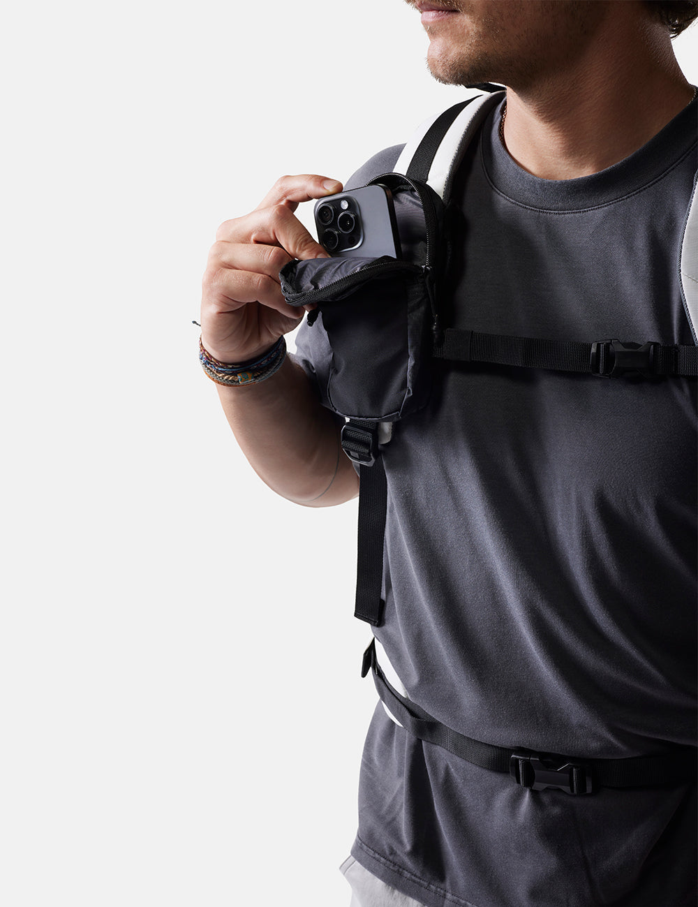 man placing phone into black speed stash on white background